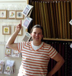 Tammy displaying quilts in one of their stores
